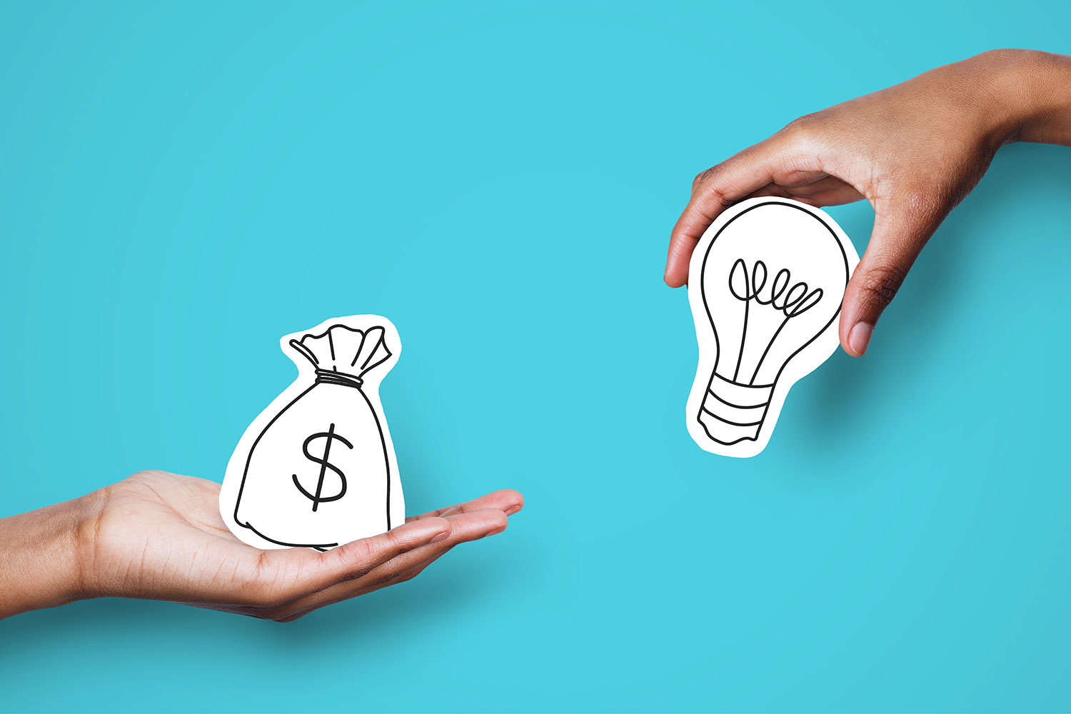 Two hands holding money and lightbulb