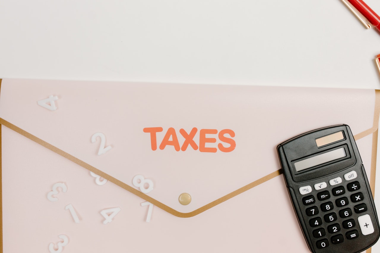 Envelope with the word taxes and a calculator